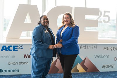 Heather Collins (right) accepted the gavel as the new president of the American Water Works Association from Cheryl Porter (left) at ACE in Denver.