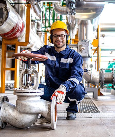 Portrait,Of,Industrial,Worker,Standing,By,High,Pressure,Valve,Inside