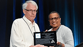 Bob James receives Fuller Award from AWWA vice president Angela Ballard-Landers.