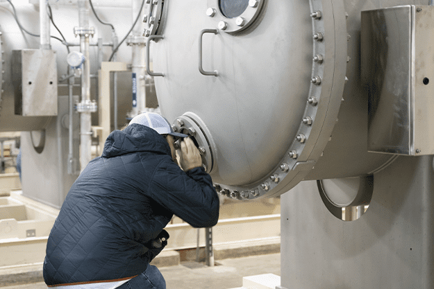 group-member-looks-inside-tank