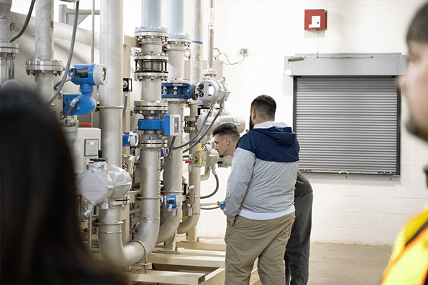 group-members-look-at-pipes