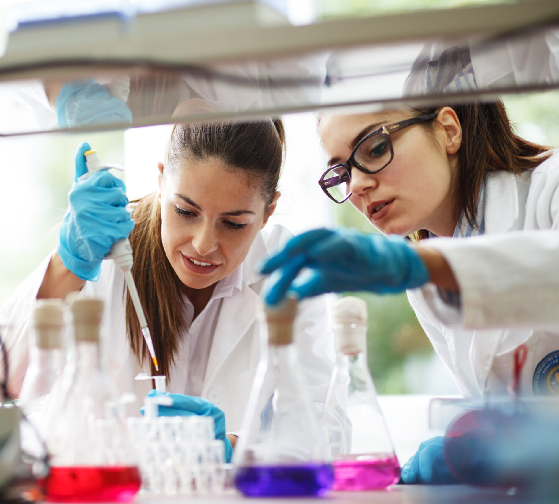 Two,Young,Female,Scientist,Doing,Experiments,In,Lab.