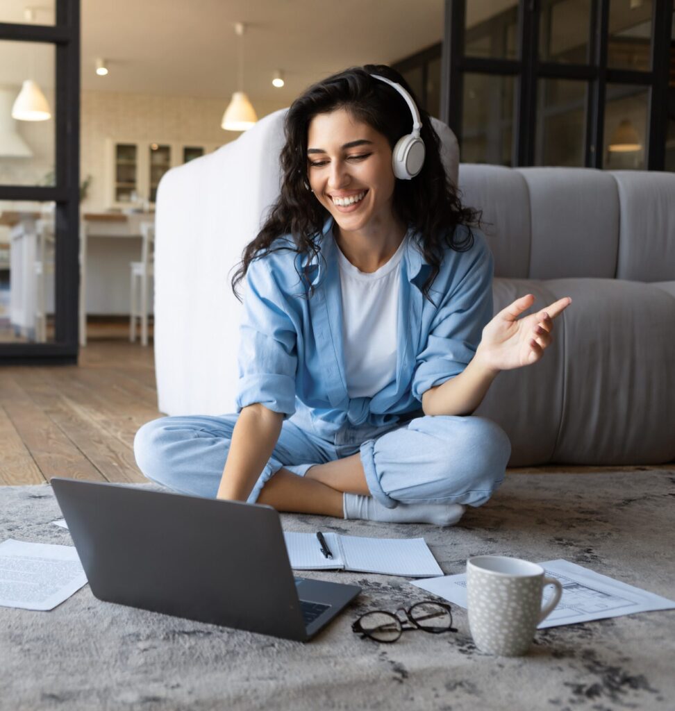 Happy,Millennial,Woman,In,Headphones,Communicating,Online,On,Laptop,,Taking